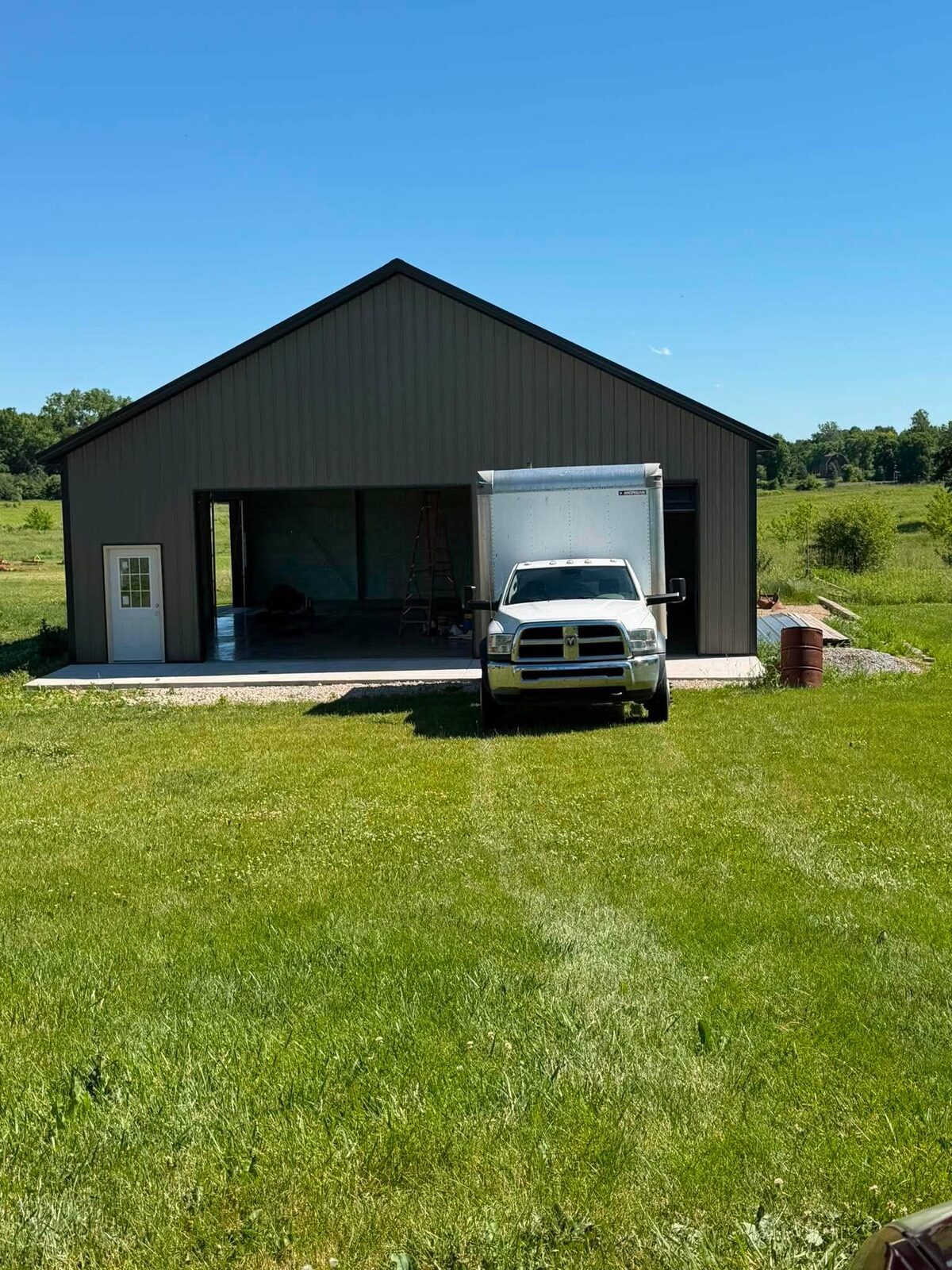 Black pole barn exterior with work truck