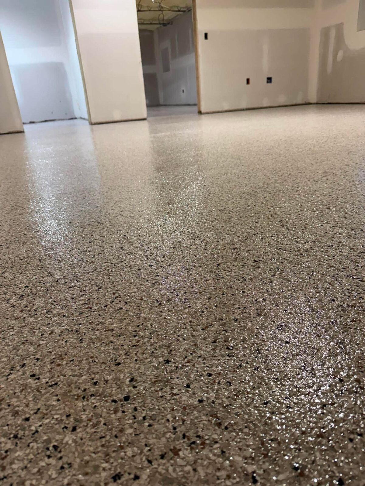 Flake epoxy floor in white-walled building