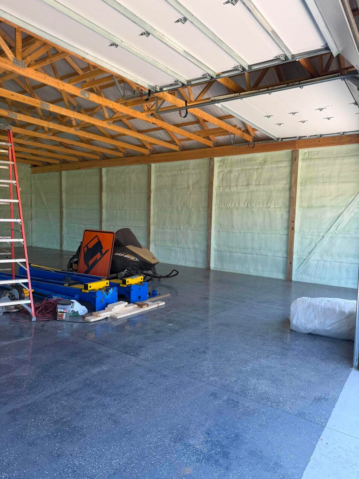 Coated floor in insulated pole barn